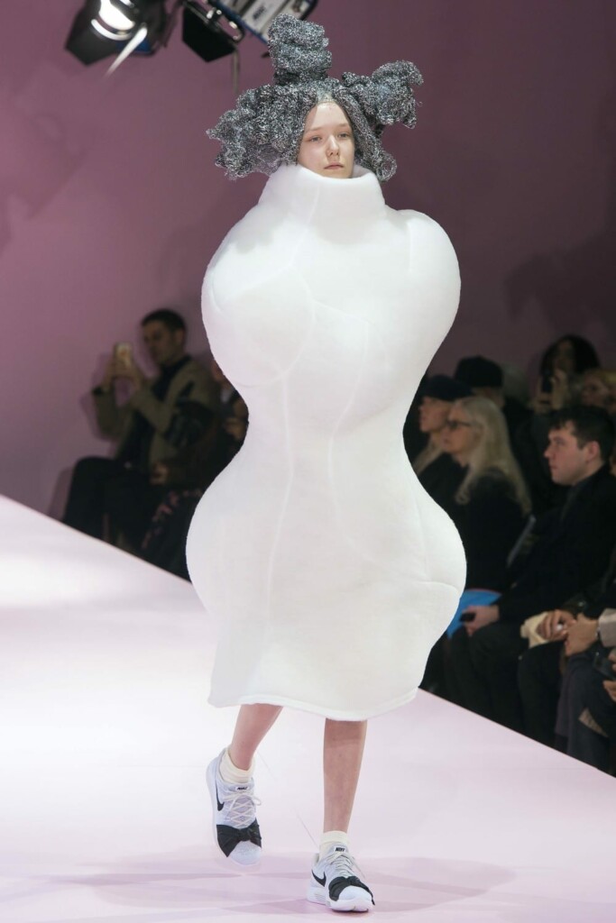woman in a white, oddly shaped, dress