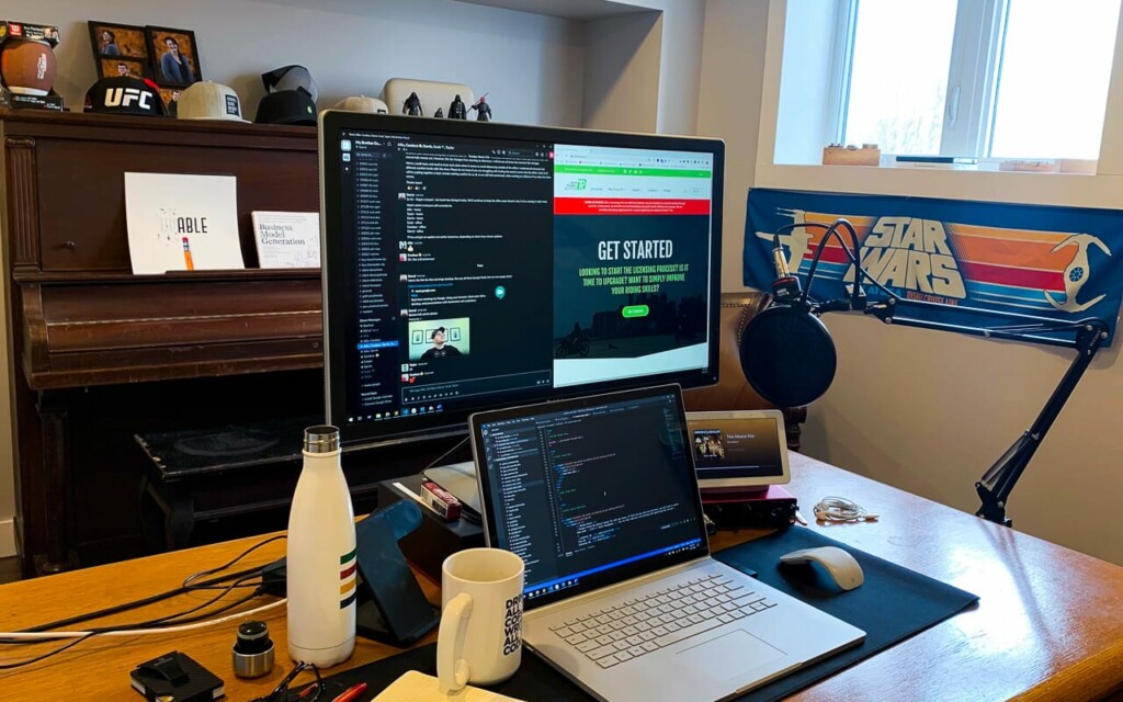 laptop with a second monitor on a wooden desk