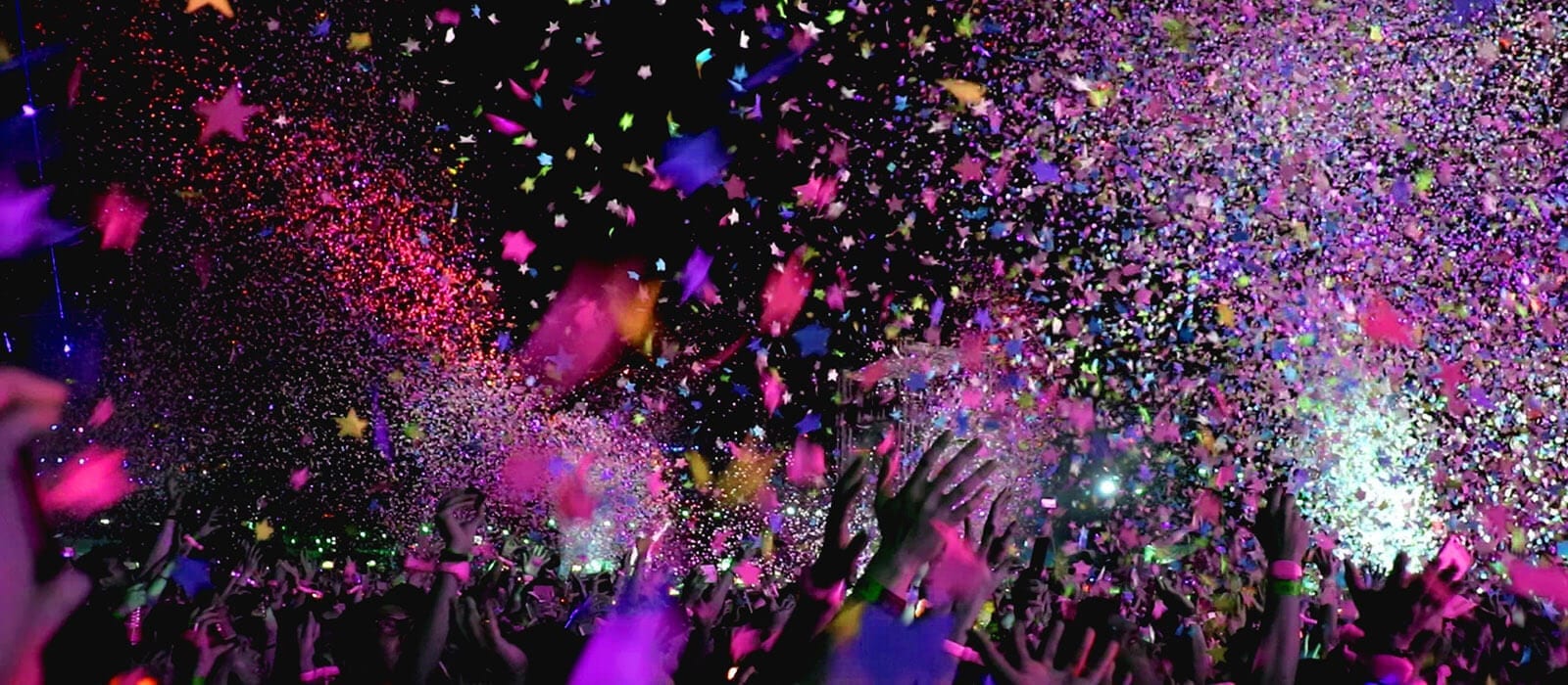 Image of bright colored falling confetti on black background
