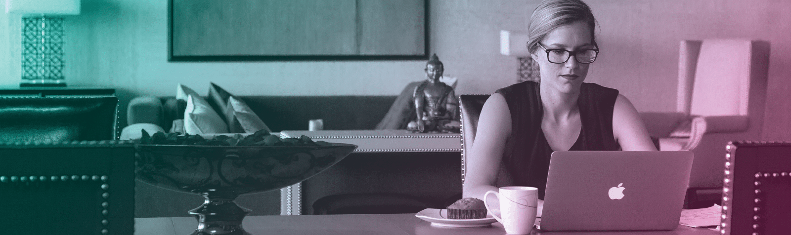 Female at desk at home on computer. Image is colored with a teal to pink gradient overlay.