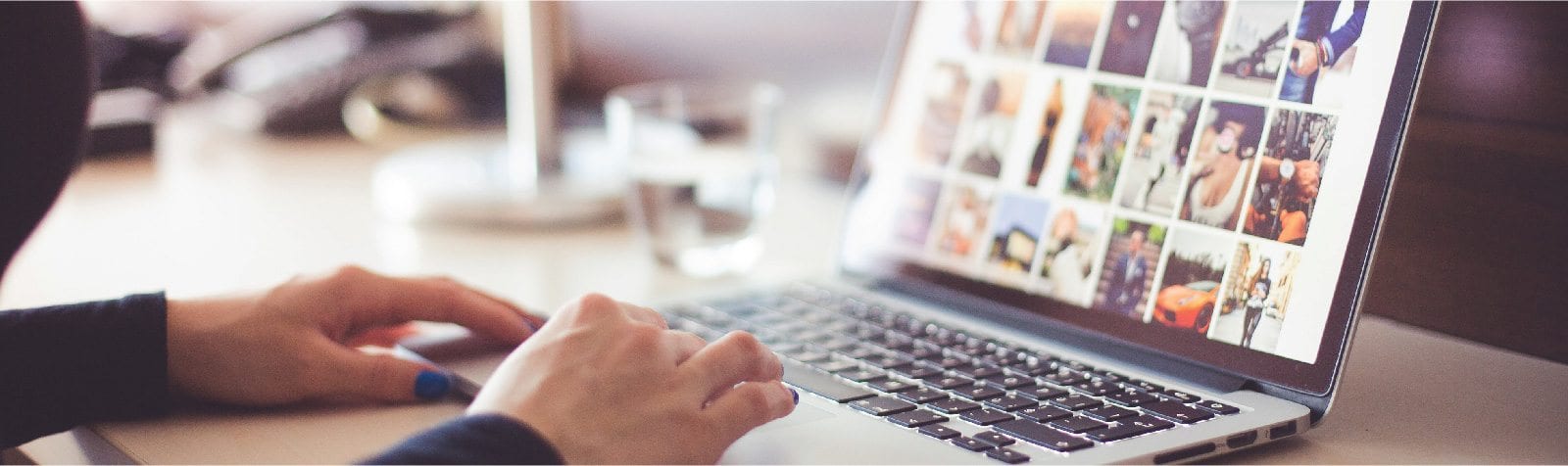 Person at laptop with lots of images on the screen