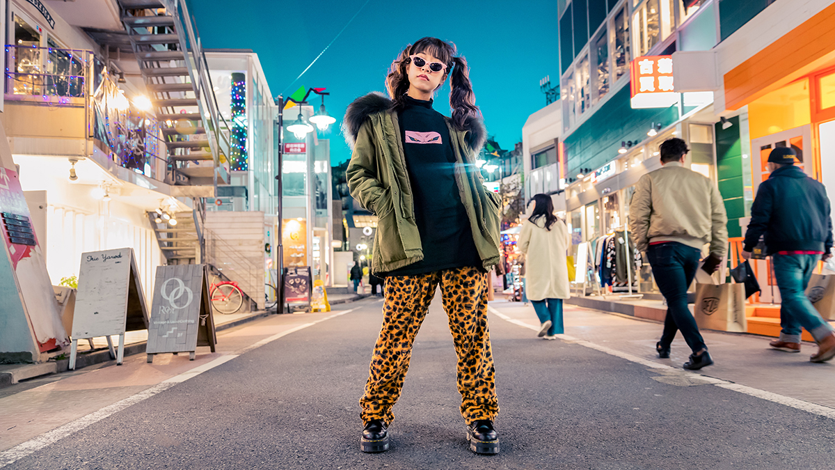 Asian woman in unique funky clothing pigtails on a busy street