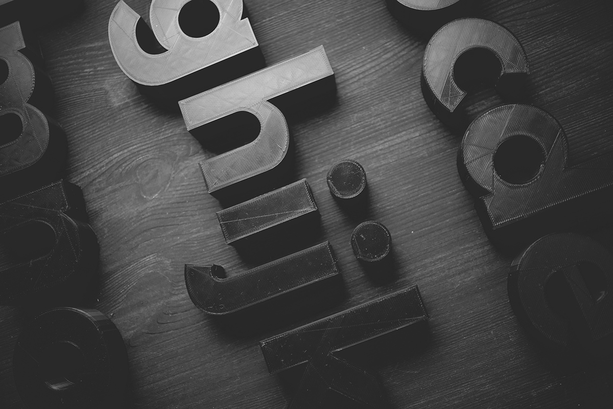 3d letters on a wood table in black and white