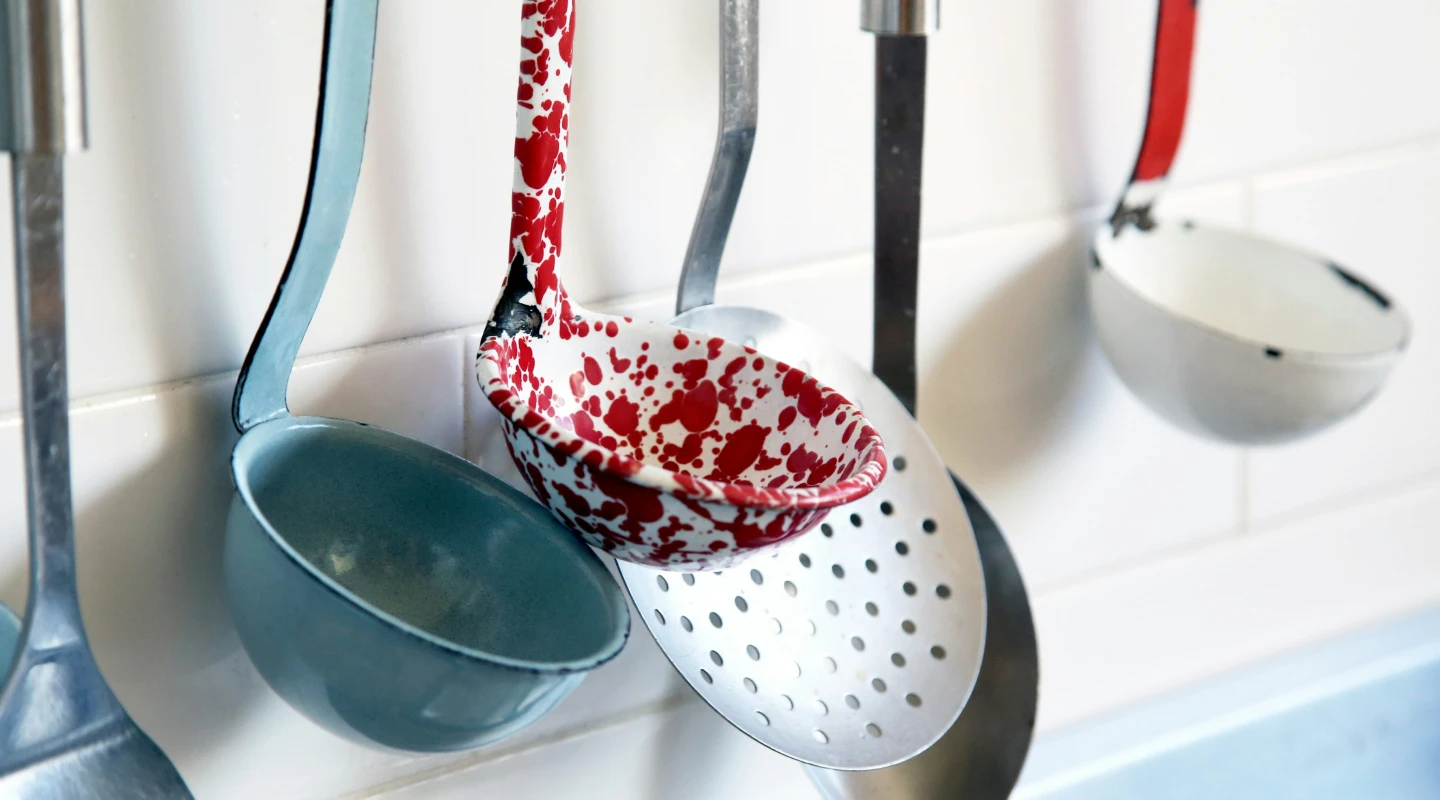 Colourful spoons hanging in a kitchen