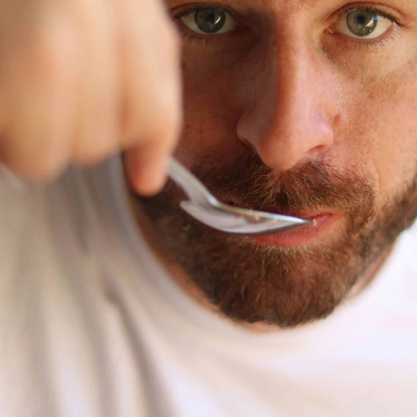 Man with spoon in his mouth