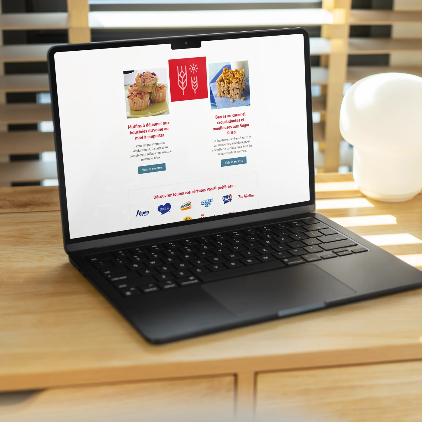 Laptop on wooden table beside a lamp. Digital Website Development by My Brother Darryl